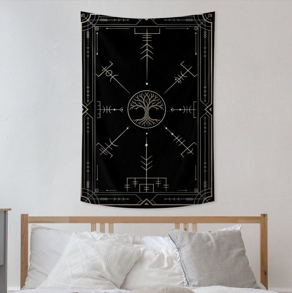 Black tapestry with white designs hanging above a bed in a bedroom.
