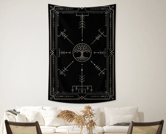 Black tapestry with white designs hanging above a living room setup.