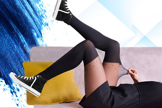 A person in black knee-high socks and black sneakers is lying on a sofa with a yellow pillow and a blue paint swoosh in the background.