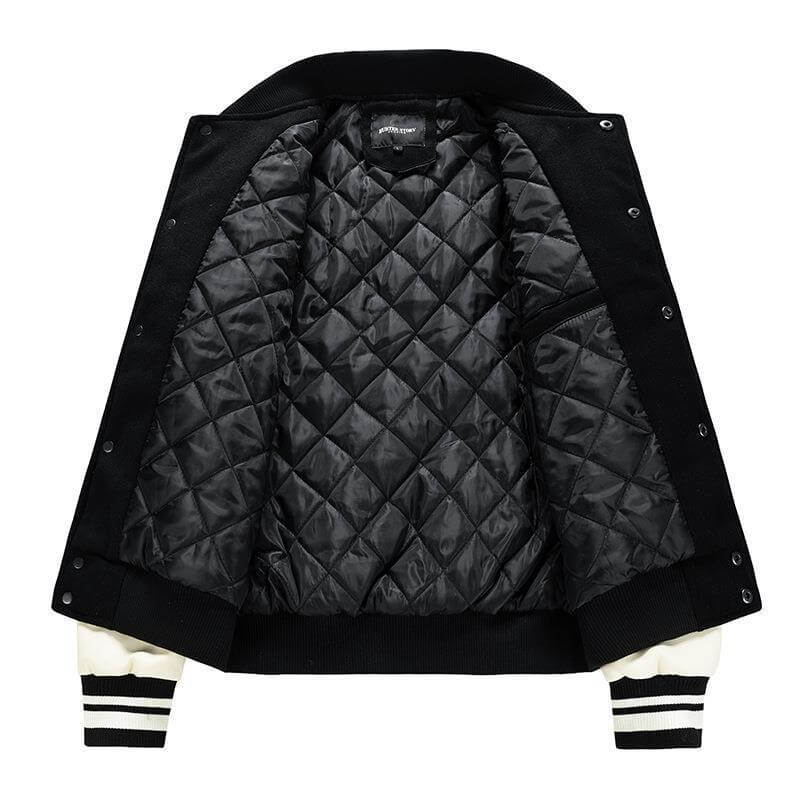 Black quilted jacket with white accents on a white background