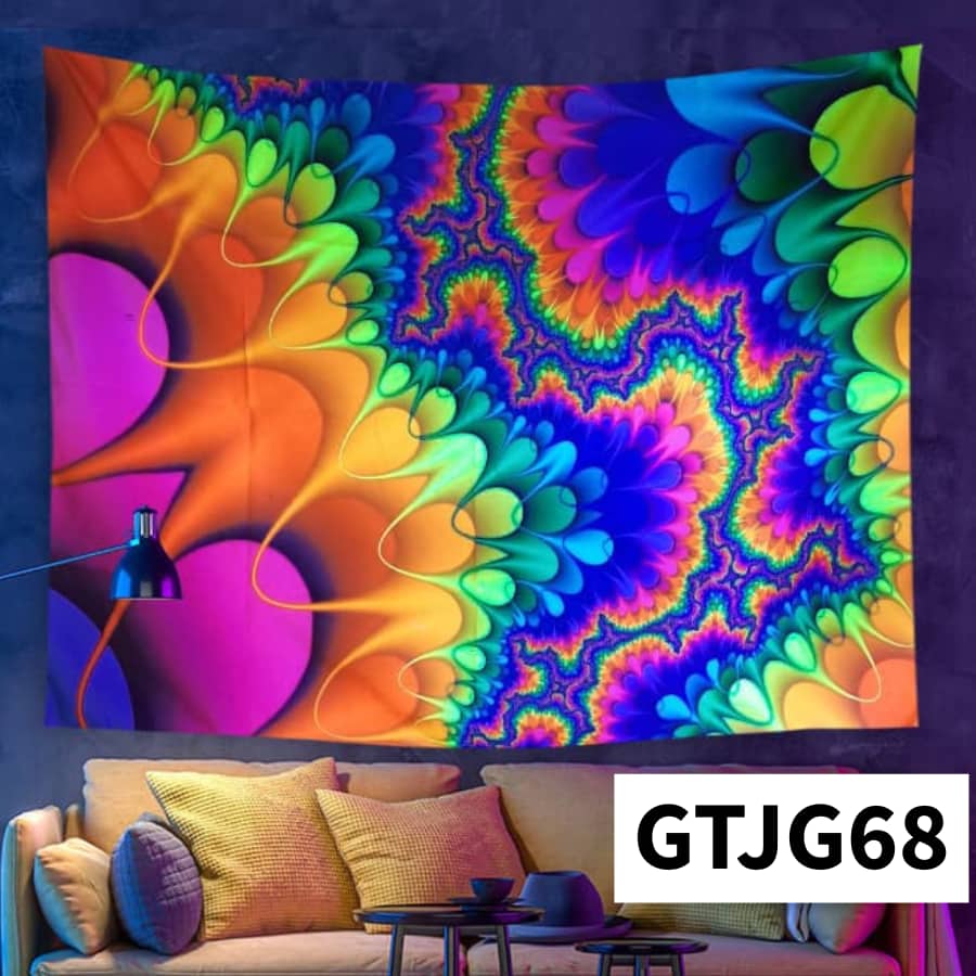 Colorful abstract tapestry hanging on a wall above a sofa with a lamp.