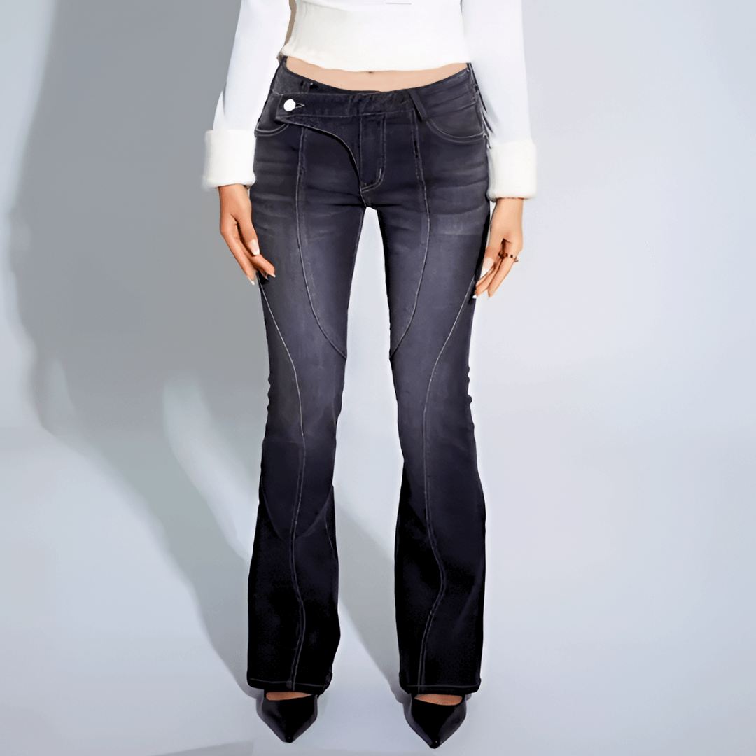 Black flared jeans worn by a person on a light gray background