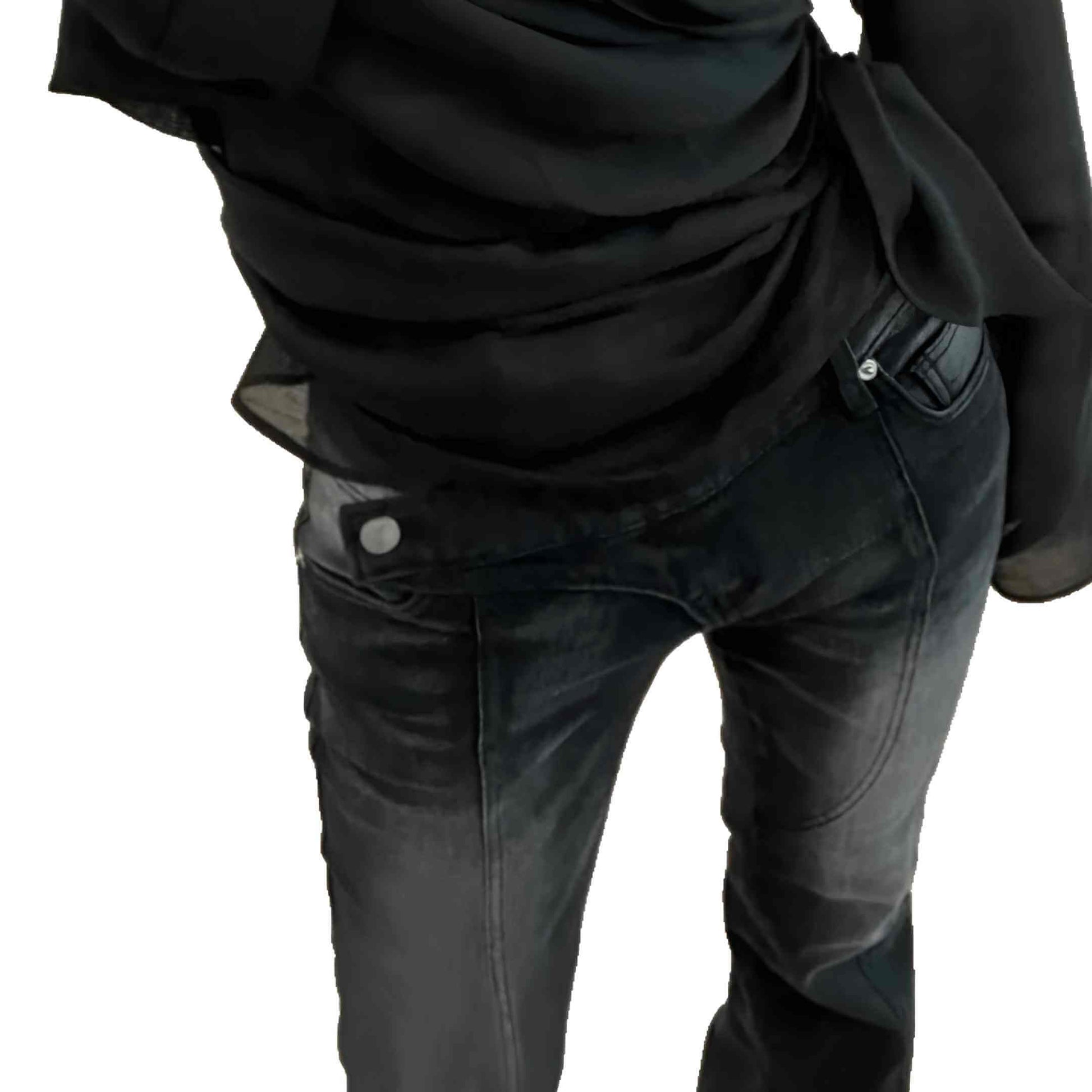 Person wearing a black shirt and dark jeans on a white background