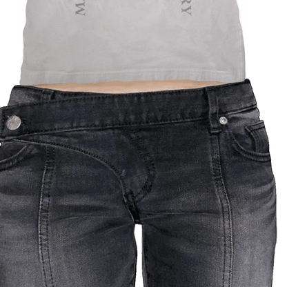 Black jeans with silver buttons worn by a person on a white background
