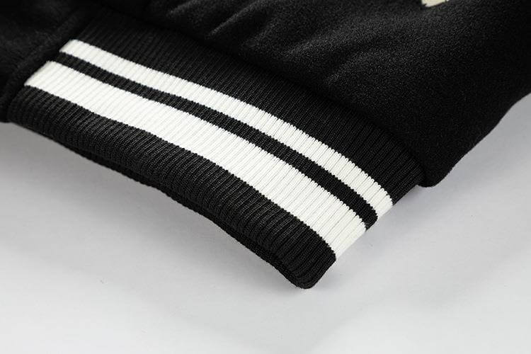 Close-up of a black jacket with white stripes on a light gray background