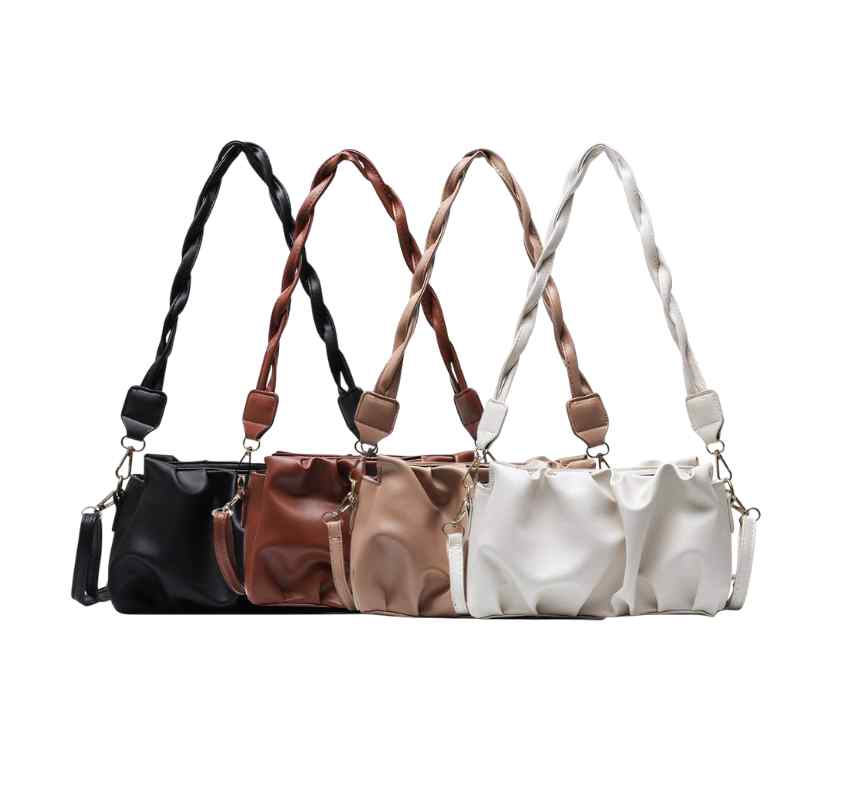 Four purses in neutral colors in a row