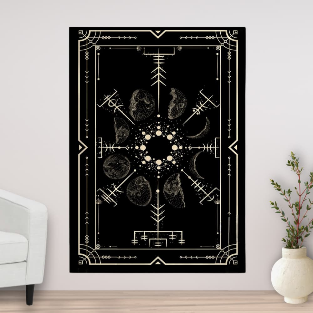 Decorative tapestry with geometric and celestial design on a wall in a room with a white armchair and plant.