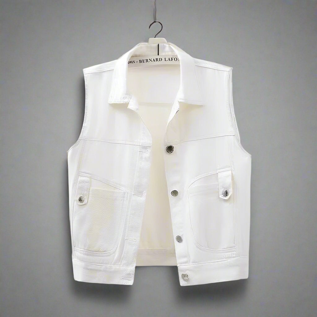 A sleeveless white denim vest with a classic design, featuring a front button closure and dual chest pockets, displayed on a mannequin.