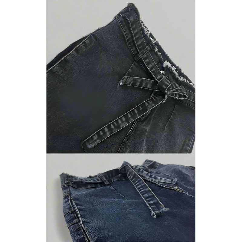 Close-up of a pair of blue jeans with frayed edges on a white background