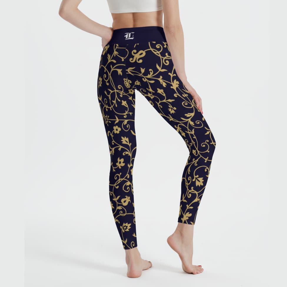 black leggings with a gold floral pattern worn by a person on a white background