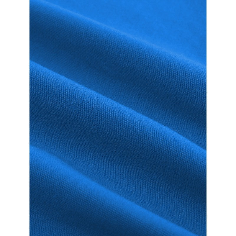 A close-up of bright blue fabric with soft diagonal folds showing a smooth knit texture.