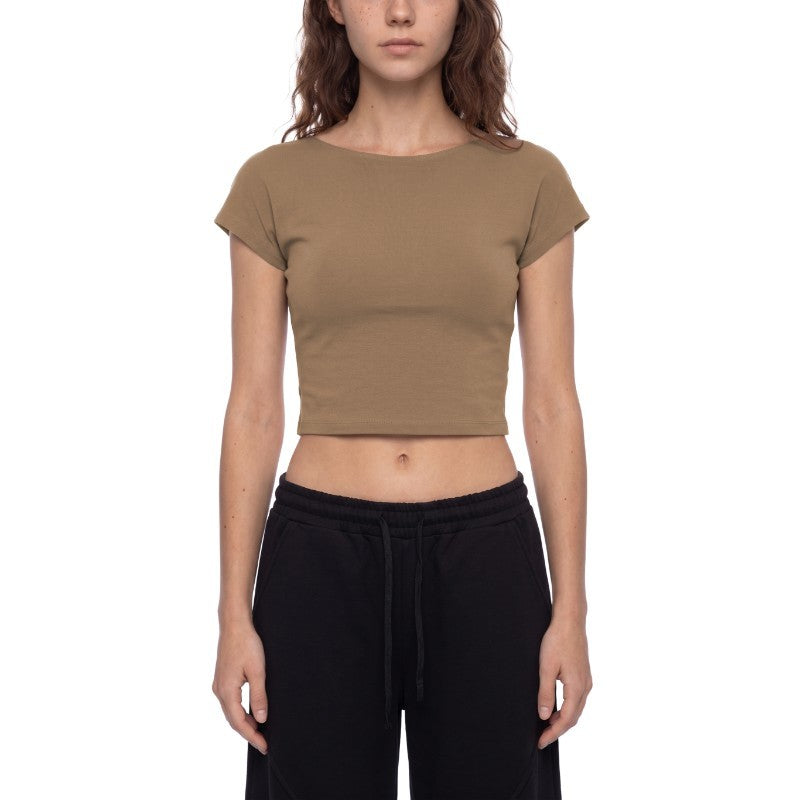A woman modeling a cropped short-sleeve t-shirt in a solid taupe-brown color, paired with black sweatpants, against a plain white background.