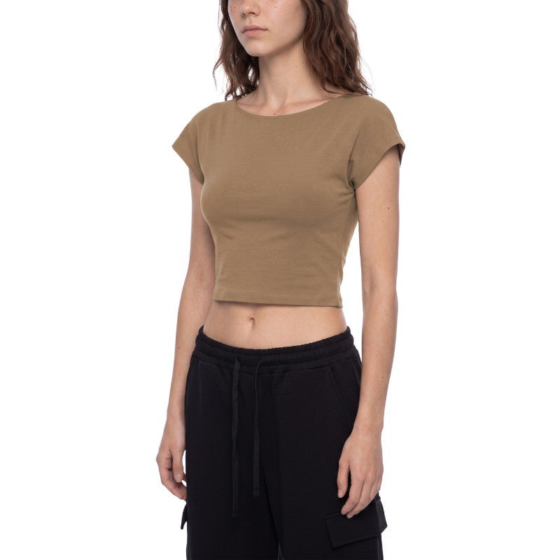 A woman wearing a cropped short-sleeve t-shirt in a warm taupe-brown color, paired with black cargo pants, shown against a plain white background.
