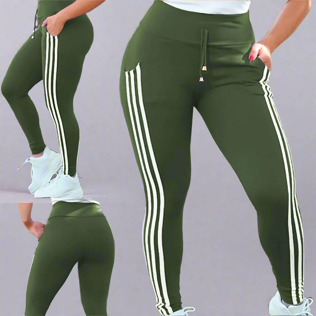 A close-up of a woman wearing green side-striped drawstring leggings with white details.