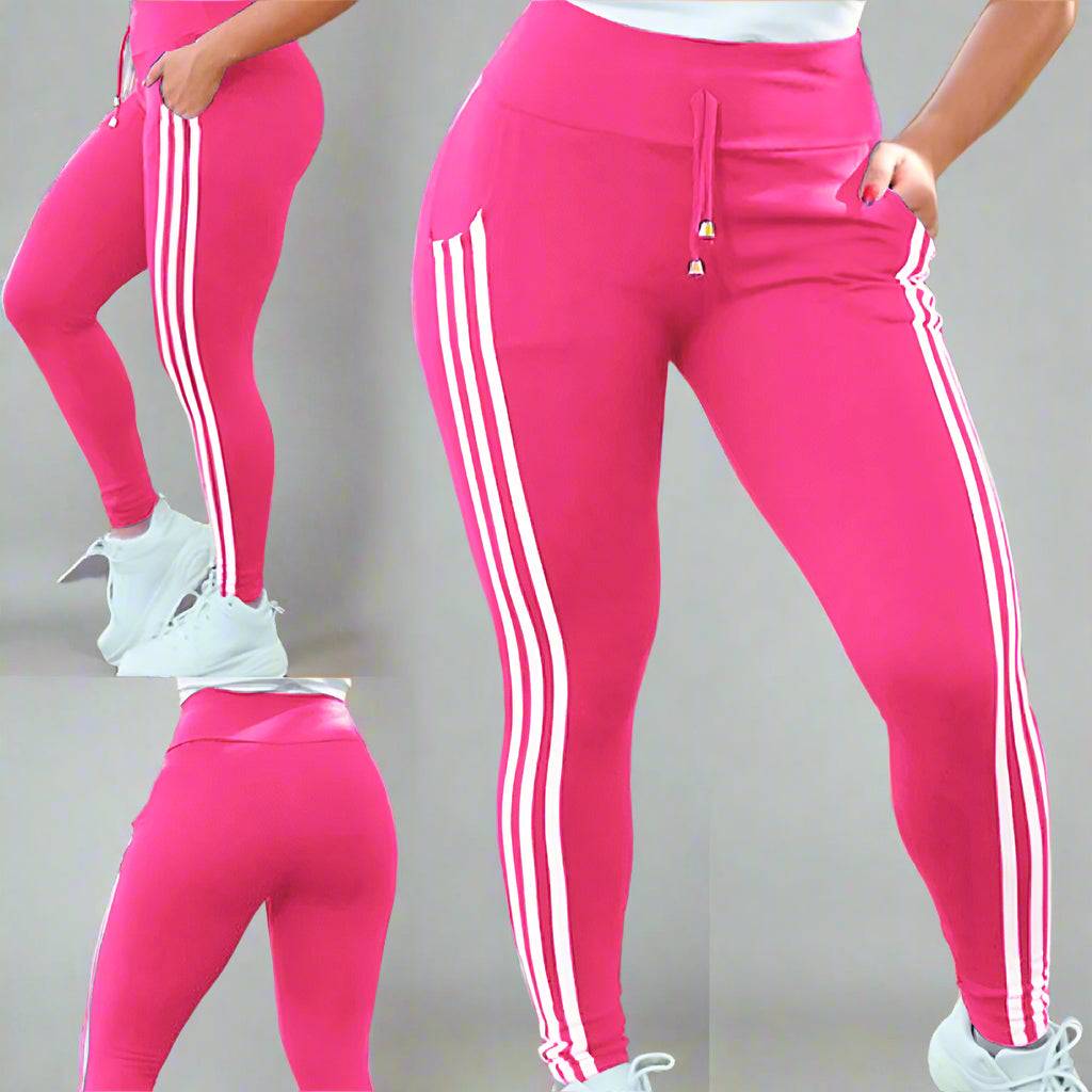 A close-up of a woman wearing pink side-striped drawstring leggings with white details.