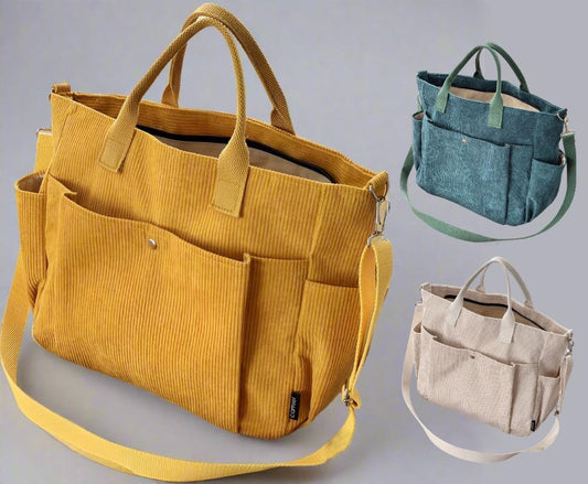 Yellow corduroy bag with multiple pockets and straps, displayed against a gray background.
