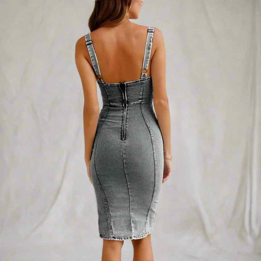 Denim dress with thin straps on a plain background
